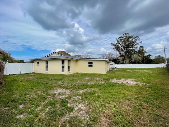 13344 Sorrento Dr, Largo, FL 33774 - rear view of property with a fenced backyard, a gate, and stucco siding