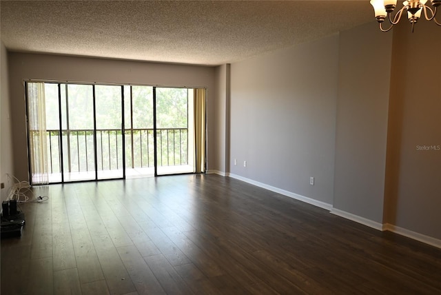 2800 Cove Cay Dr Unit 5D, Clearwater, FL 33760 - empty room featuring a textured ceiling, a chandelier, and dark wood-style flooring