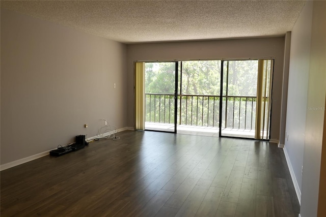 2800 Cove Cay Dr Unit 5D, Clearwater, FL 33760 - empty room featuring a textured ceiling and dark wood-style floors