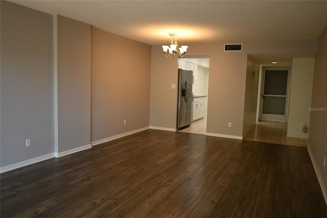 2800 Cove Cay Dr Unit 5D, Clearwater, FL 33760 - spare room featuring a chandelier, wood finished floors, and a textured ceiling