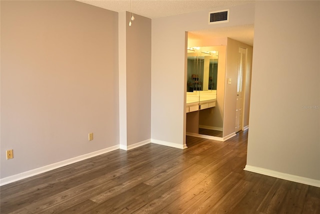 2800 Cove Cay Dr Unit 5D, Clearwater, FL 33760 - unfurnished room with dark wood-style flooring and a textured ceiling