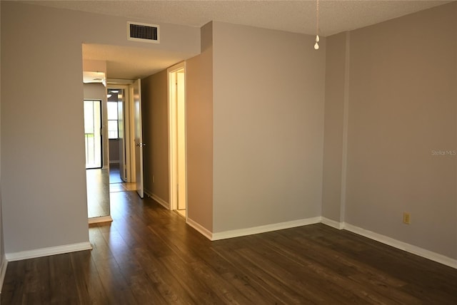2800 Cove Cay Dr Unit 5D, Clearwater, FL 33760 - spare room featuring dark wood-style floors and a textured ceiling