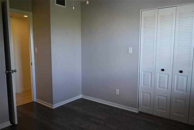 2800 Cove Cay Dr Unit 5D, Clearwater, FL 33760 - unfurnished bedroom featuring dark wood finished floors and a closet