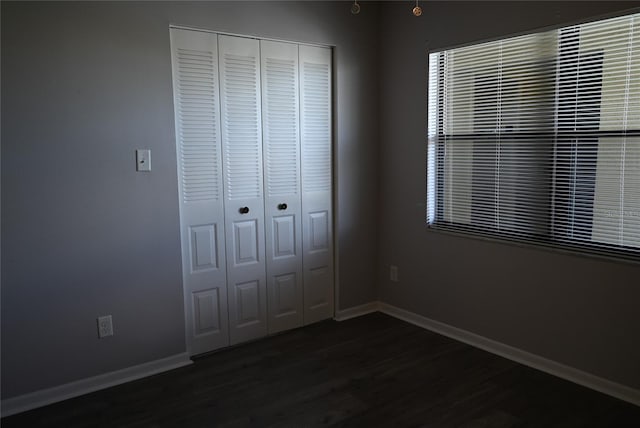 2800 Cove Cay Dr Unit 5D, Clearwater, FL 33760 - unfurnished bedroom featuring a closet and wood finished floors