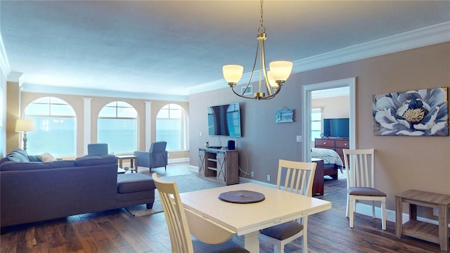 4950 Gulf Blvd Unit 1006, St Pete Beach, FL 33706 - dining space featuring crown molding, a chandelier, and dark wood-style floors