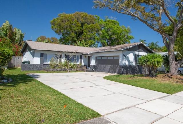 574 6th Ave SE, Largo, FL 33771 - ranch-style home with stucco siding, a garage, and concrete driveway
