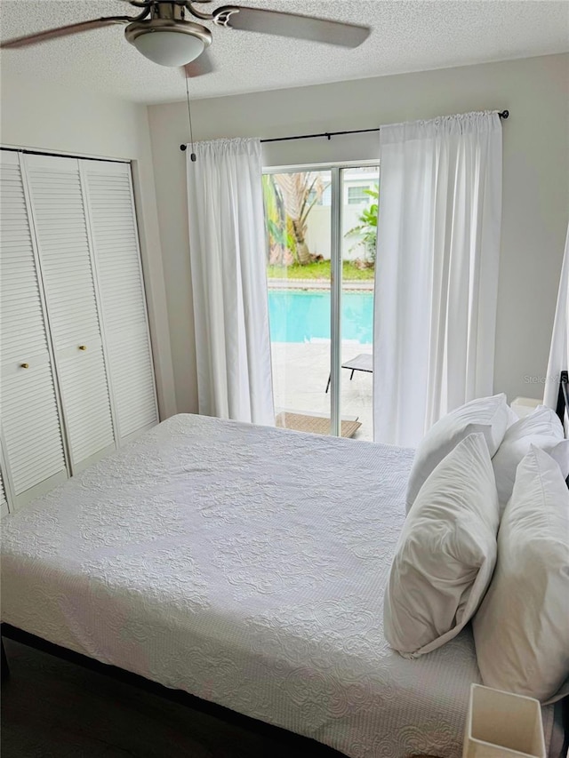 574 6th Ave SE, Largo, FL 33771 - bedroom featuring access to exterior, a ceiling fan, a closet, and a textured ceiling