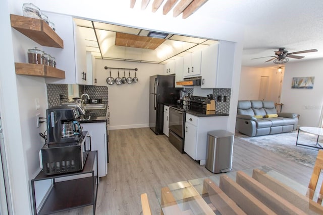 574 6th Ave SE, Largo, FL 33771 - kitchen featuring electric range, open shelves, ventilation hood, dark countertops, and white cabinetry