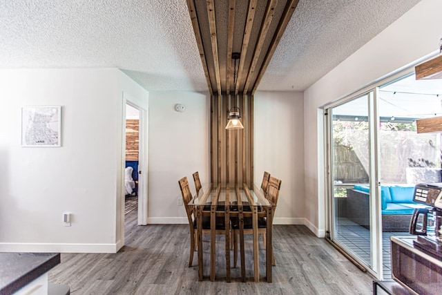 574 6th Ave SE, Largo, FL 33771 - dining room with wood finished floors and a textured ceiling