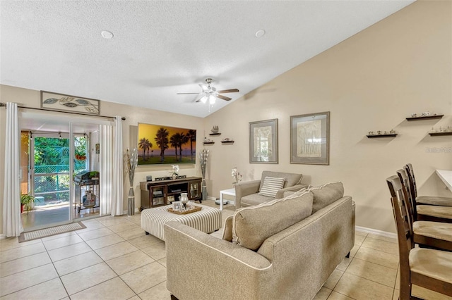 1150 Jade E Ln, Kissimmee, FL 34744 - living area with light tile patterned flooring, a ceiling fan, vaulted ceiling, and a textured ceiling