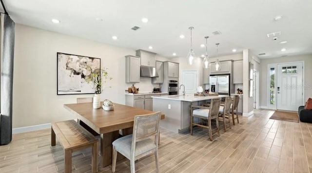 2422 Babbling Brook Blvd, Auburndale, FL 33823 - dining space with light wood-style flooring and recessed lighting