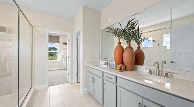 2422 Babbling Brook Blvd, Auburndale, FL 33823 - full bath featuring a shower stall, double vanity, healthy amount of natural light, and tile patterned floors