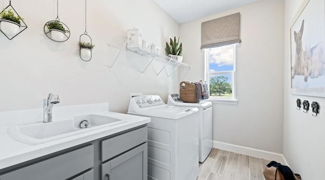 2422 Babbling Brook Blvd, Auburndale, FL 33823 - washroom with washing machine and clothes dryer, cabinet space, and light wood finished floors