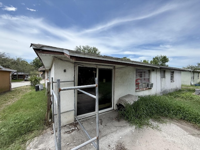 13097 120th St, Largo, FL 33778 - rear view of house with stucco siding and cooling unit