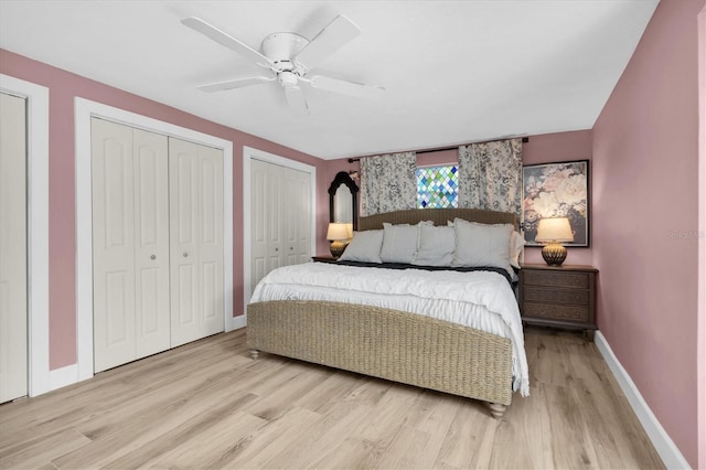2009 Woodward Ave, Dunedin, FL 34698 - bedroom with multiple closets, light wood-style flooring, and a ceiling fan