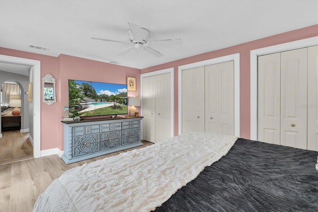 2009 Woodward Ave, Dunedin, FL 34698 - bedroom with wood finished floors, multiple closets, and a ceiling fan