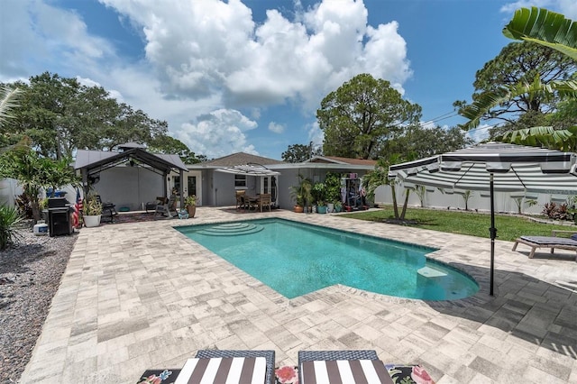 2009 Woodward Ave, Dunedin, FL 34698 - outdoor pool with a patio, outdoor dining space, and area for grilling