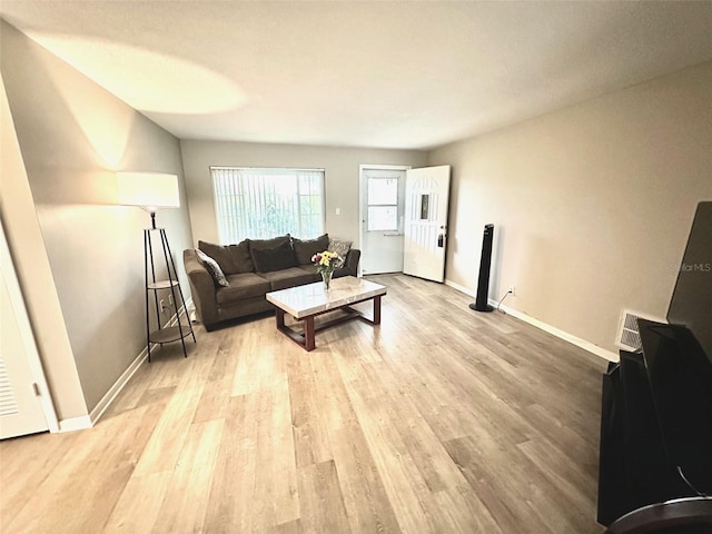 9830 44th Way N, Pinellas Park, FL 33782 - living area featuring light wood-style flooring and baseboards