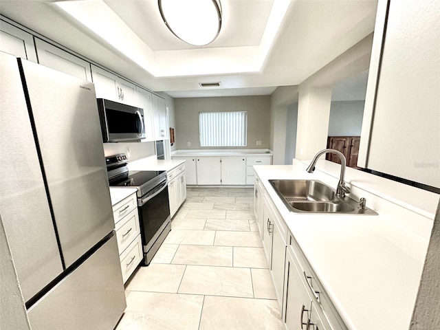 9830 44th Way N, Pinellas Park, FL 33782 - kitchen with stainless steel appliances, light countertops, and a raised ceiling