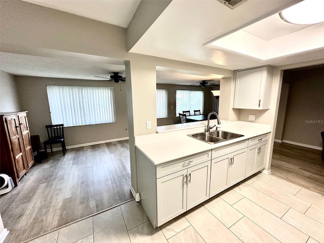 9830 44th Way N, Pinellas Park, FL 33782 - kitchen with ceiling fan, light countertops, and light wood-style floors