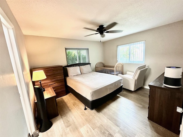 9830 44th Way N, Pinellas Park, FL 33782 - bedroom featuring wood finished floors, a textured ceiling, and a ceiling fan