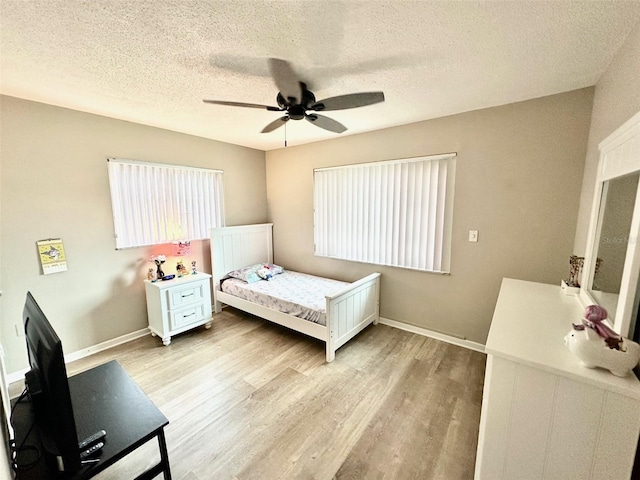 9830 44th Way N, Pinellas Park, FL 33782 - bedroom with a textured ceiling, light wood-style flooring, and ceiling fan