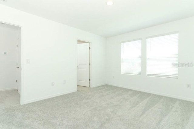 2555 Driftwood St, Auburndale, FL 33823 - spare room featuring light carpet and baseboards