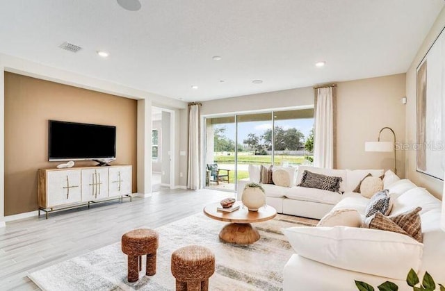 2257 Cypress Creek St, Auburndale, FL 33823 - living room featuring wood finished floors and recessed lighting