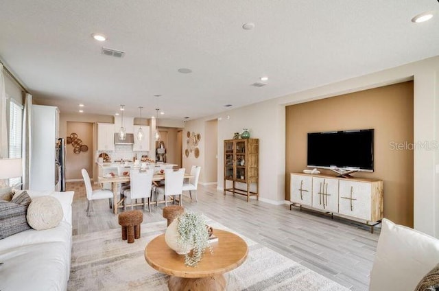 2257 Cypress Creek St, Auburndale, FL 33823 - living room featuring recessed lighting and light wood-style floors