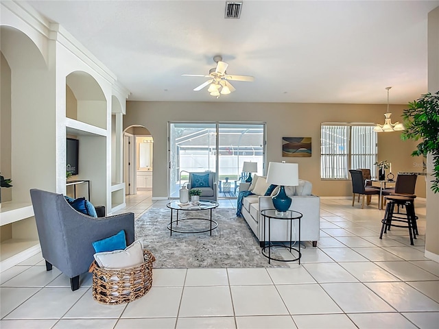 9803 Ocasta St, Riverview, FL 33569 - living area featuring arched walkways, plenty of natural light, ceiling fan, and light tile patterned floors
