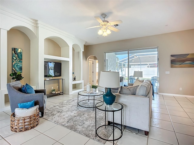 9803 Ocasta St, Riverview, FL 33569 - living area featuring arched walkways, tile patterned floors, and a ceiling fan