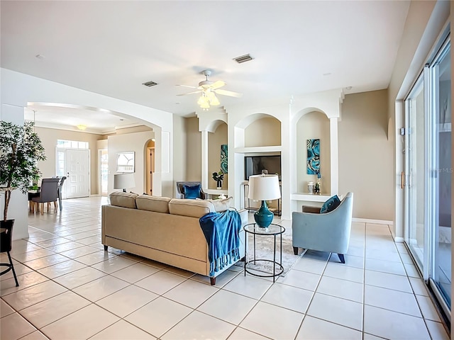 9803 Ocasta St, Riverview, FL 33569 - living room with light tile patterned floors, a ceiling fan, arched walkways, and built in features