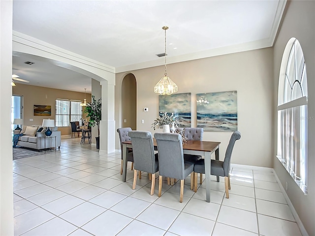 9803 Ocasta St, Riverview, FL 33569 - dining space with a chandelier, arched walkways, and light tile patterned floors