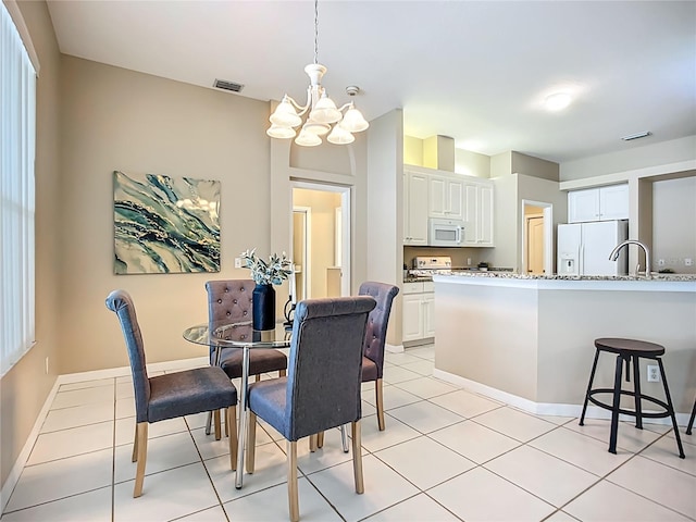9803 Ocasta St, Riverview, FL 33569 - dining area featuring a chandelier and light tile patterned floors