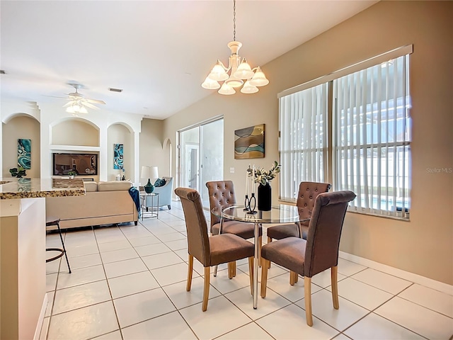9803 Ocasta St, Riverview, FL 33569 - dining area featuring a chandelier, light tile patterned flooring, arched walkways, and ceiling fan