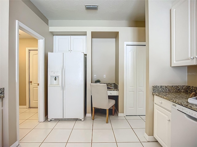 9803 Ocasta St, Riverview, FL 33569 - kitchen featuring white appliances, white cabinetry, dark stone countertops, and built in desk
