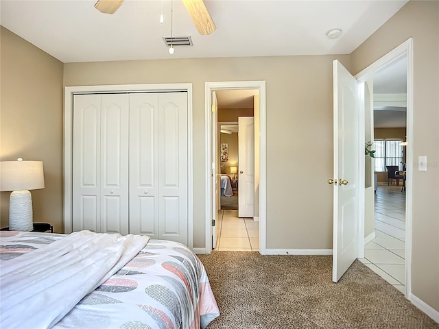 9803 Ocasta St, Riverview, FL 33569 - bedroom with a closet, light colored carpet, a ceiling fan, and light tile patterned floors