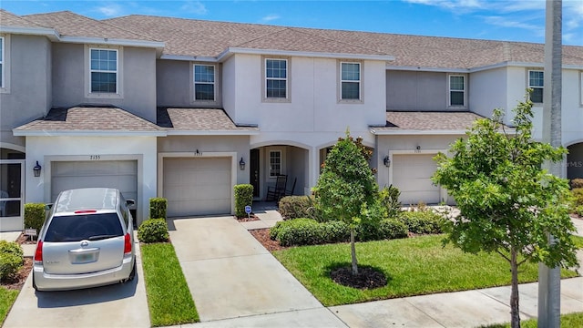 7133 Summer Holly Pl, Riverview, FL 33578 - traditional-style home with roof with shingles, stucco siding, concrete driveway, and an attached garage