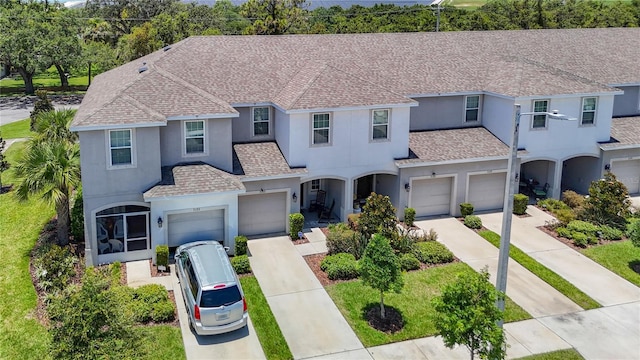 7133 Summer Holly Pl, Riverview, FL 33578 - traditional home featuring stucco siding, roof with shingles, and driveway