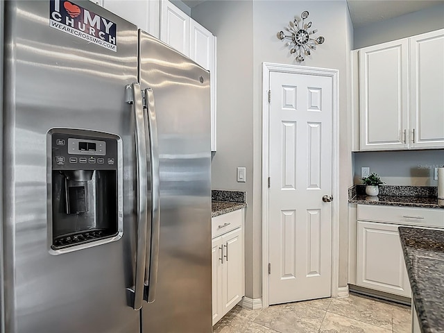 7133 Summer Holly Pl, Riverview, FL 33578 - kitchen with stainless steel fridge, white cabinetry, and dark stone countertops