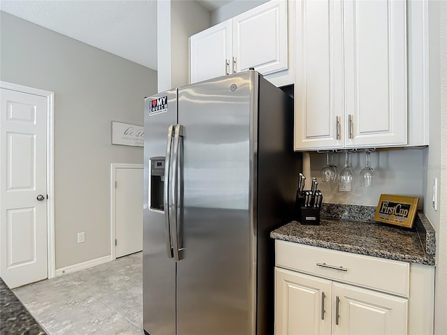 7133 Summer Holly Pl, Riverview, FL 33578 - kitchen featuring stainless steel fridge, white cabinets, and dark stone countertops