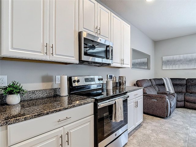 7133 Summer Holly Pl, Riverview, FL 33578 - kitchen featuring appliances with stainless steel finishes, open floor plan, white cabinets, and dark stone countertops