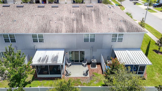 7133 Summer Holly Pl, Riverview, FL 33578 - rear view of property with stucco siding, a sunroom, and a shingled roof