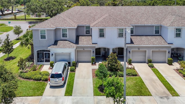7133 Summer Holly Pl, Riverview, FL 33578 - traditional home with stucco siding, driveway, a shingled roof, and an attached garage