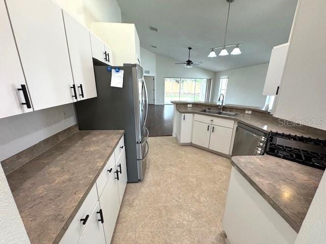 24838 Oakhaven Ct, Lutz, FL 33559 - kitchen featuring ceiling fan, vaulted ceiling, white cabinets, decorative light fixtures, and stainless steel appliances