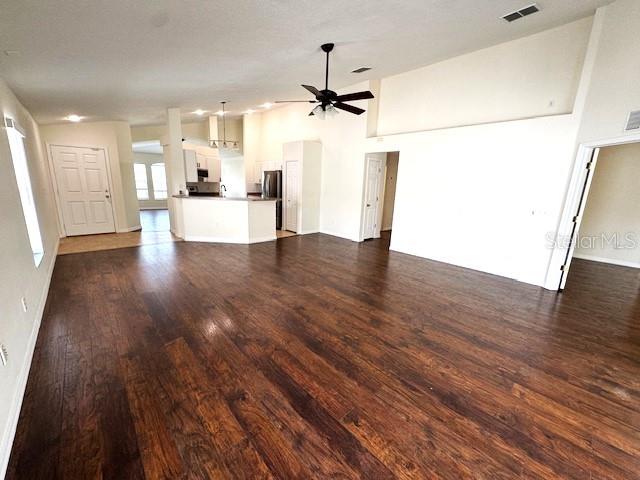 24838 Oakhaven Ct, Lutz, FL 33559 - unfurnished living room with a ceiling fan and dark wood-style floors