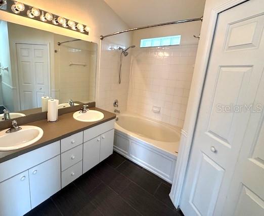 24838 Oakhaven Ct, Lutz, FL 33559 - full bath featuring shower / washtub combination, double vanity, and tile patterned flooring