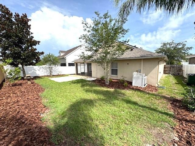 24838 Oakhaven Ct, Lutz, FL 33559 - back of house with stucco siding, a fenced backyard, a shingled roof, and a patio area