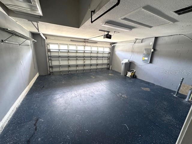 24838 Oakhaven Ct, Lutz, FL 33559 - garage featuring electric panel and baseboards