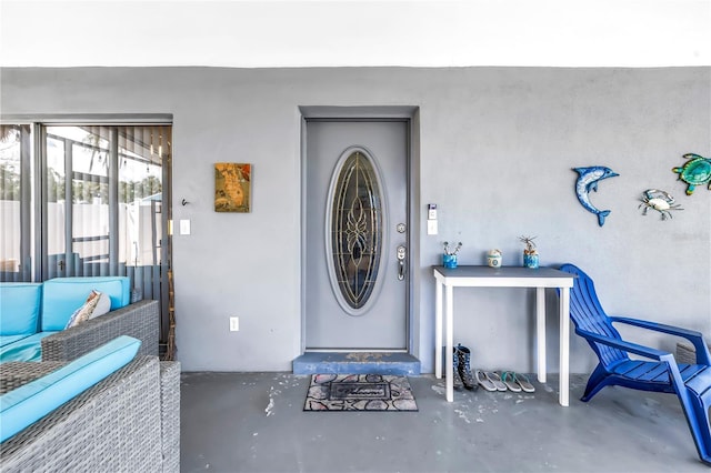 360 71st Ave, St Pete Beach, FL 33706 - property entrance featuring stucco siding and outdoor lounge area
